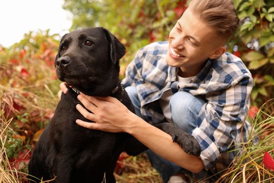 Smiling man with cute dog outdoors on autumn day