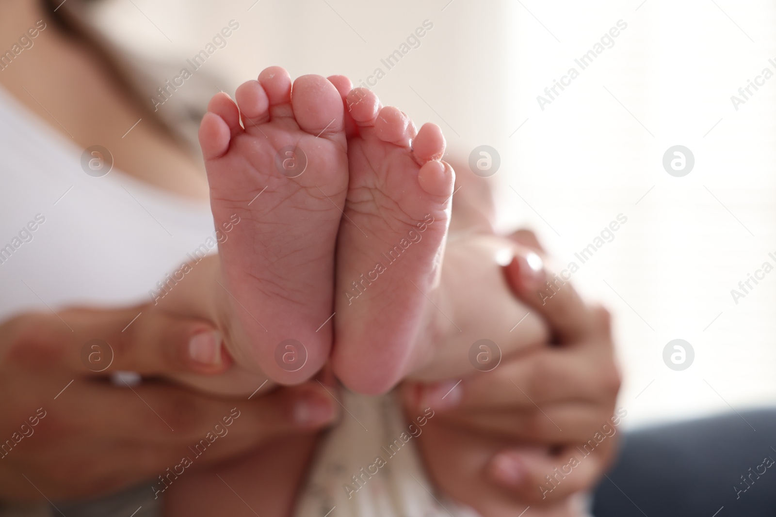 Photo of Mother with her cute little baby at home, closeup