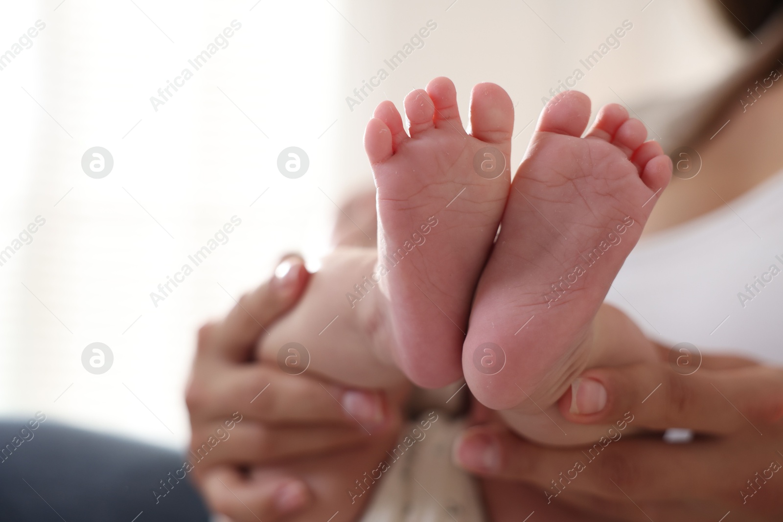 Photo of Mother with her cute little baby at home, closeup