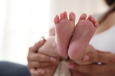 Mother with her cute little baby at home, closeup