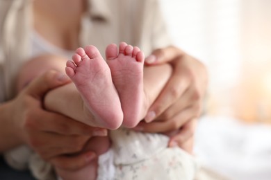 Mother with her cute little baby at home, closeup. Space for text