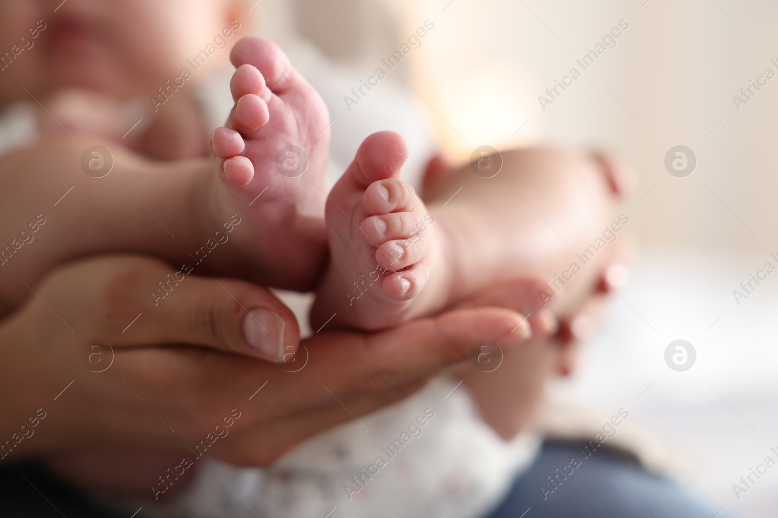 Photo of Mother with her cute little baby at home, closeup