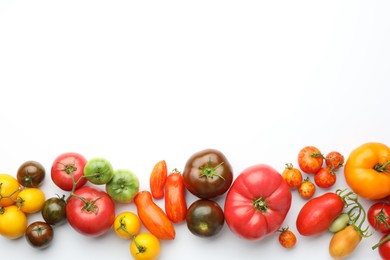 Different ripe tomatoes on white background, top view. Space for text