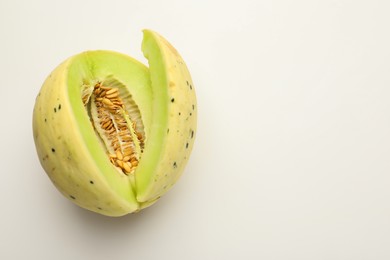 Photo of Cut fresh ripe honeydew melon on white background, space for text