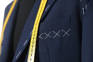 Photo of Semi-ready jacket and measuring tape on mannequin, closeup