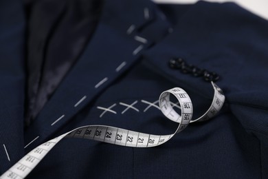 Elegant semi-ready jacket and measuring tape, closeup