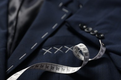 Photo of Elegant semi-ready jacket and measuring tape, closeup