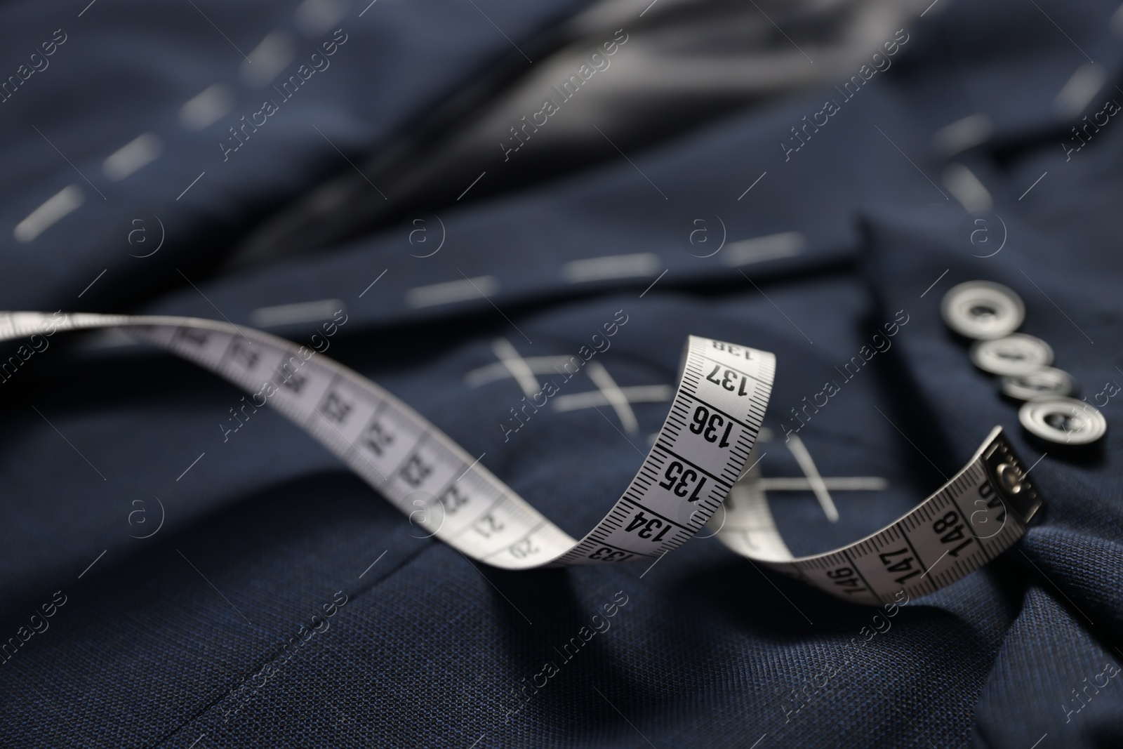 Photo of Elegant semi-ready jacket and measuring tape, closeup