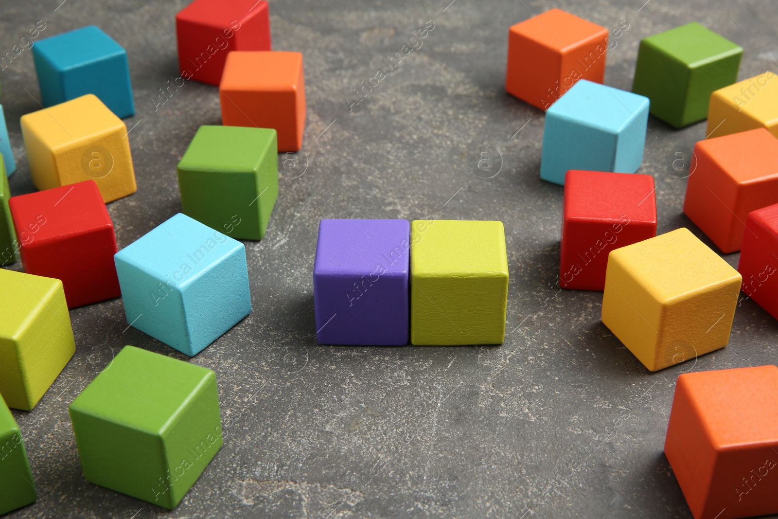 Photo of Many wooden colorful cubes on gray textured background