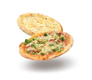 Different pizzas in air on white background