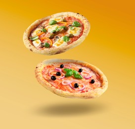 Image of Different pizzas in air on orange gradient background