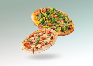 Different pizzas in air on gradient background