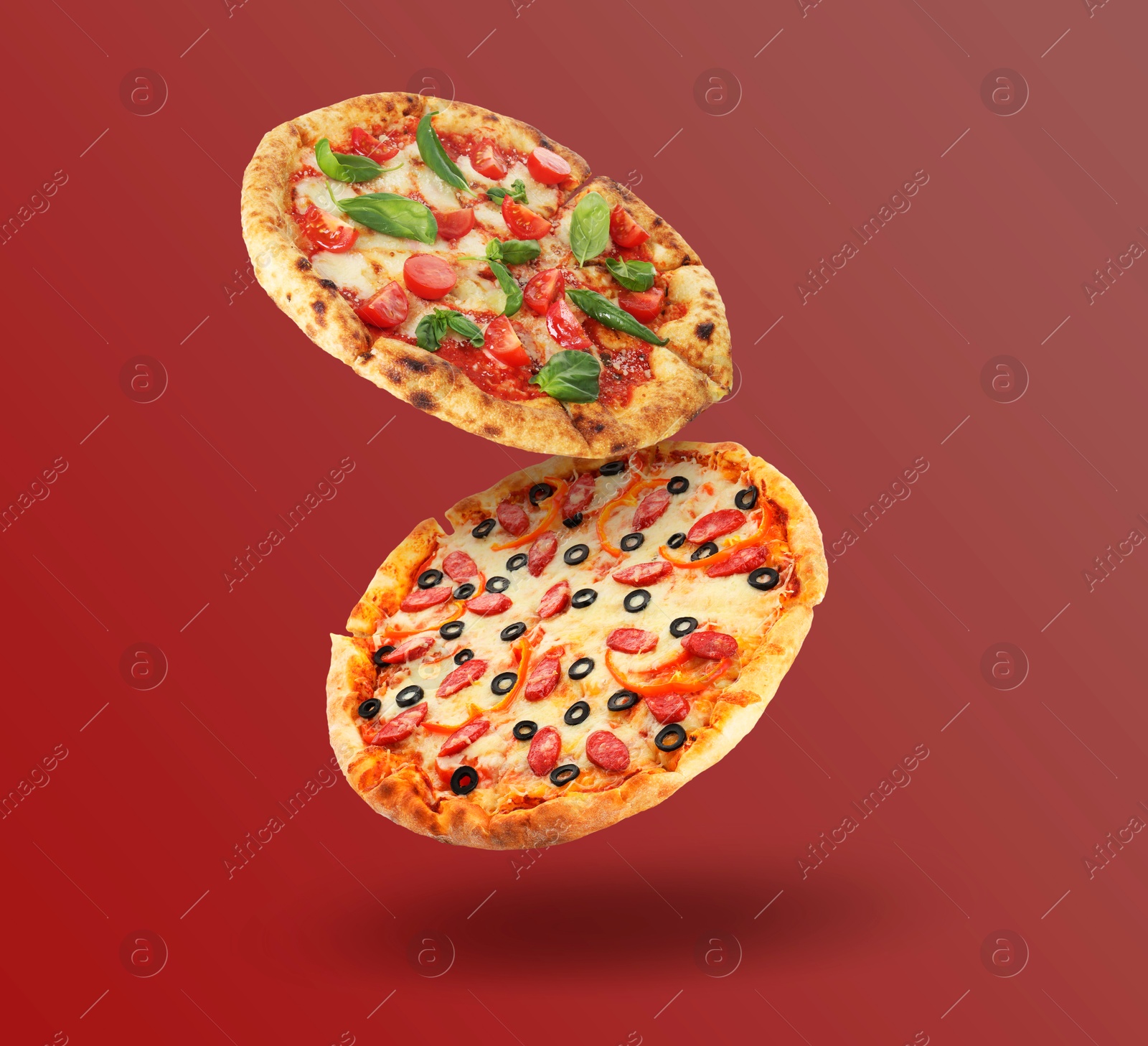 Image of Different pizzas in air on red gradient background