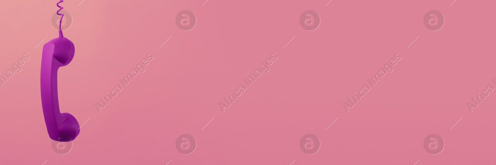 Image of Purple corded telephone handset on pink background. Banner design with space for text