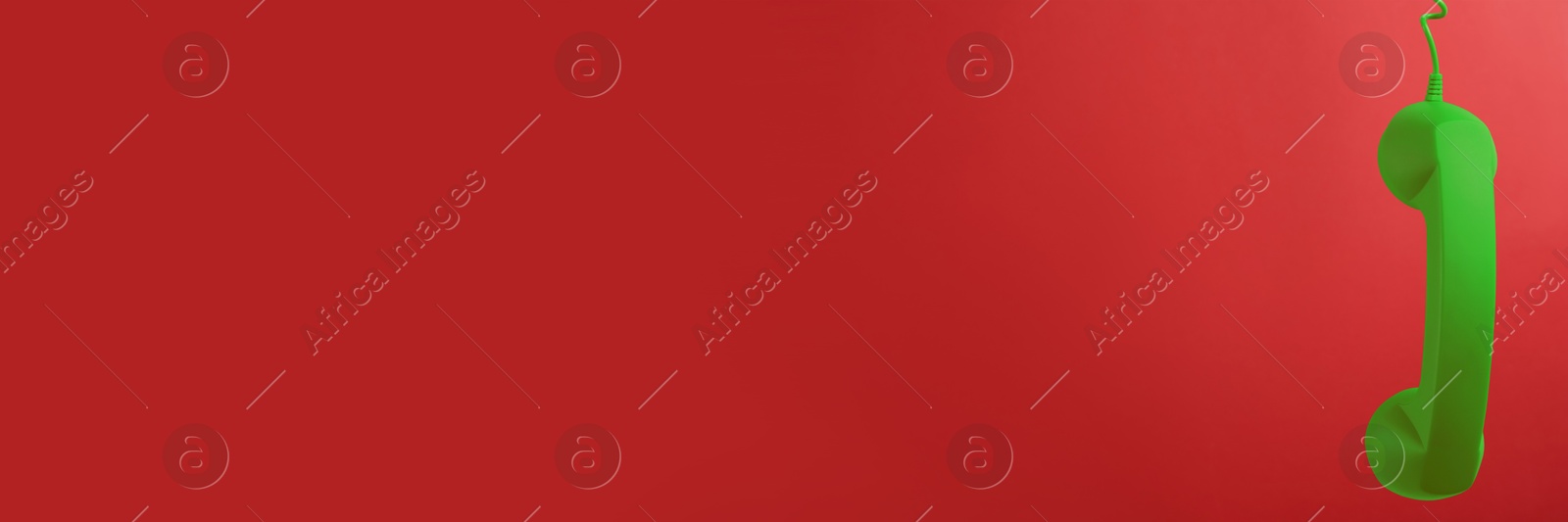 Image of Green corded telephone handset on red background. Banner design with space for text