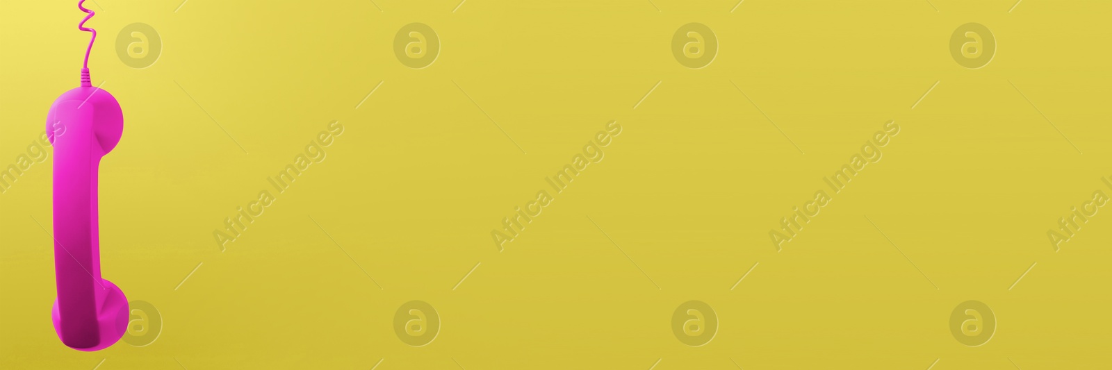 Image of Magenta color telephone handset on yellow background. Banner design with space for text