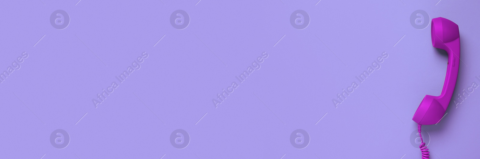 Image of Purple corded telephone handset on violet background, top view. Banner design with space for text