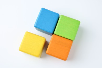 Photo of Many wooden colorful cubes on white background, top view