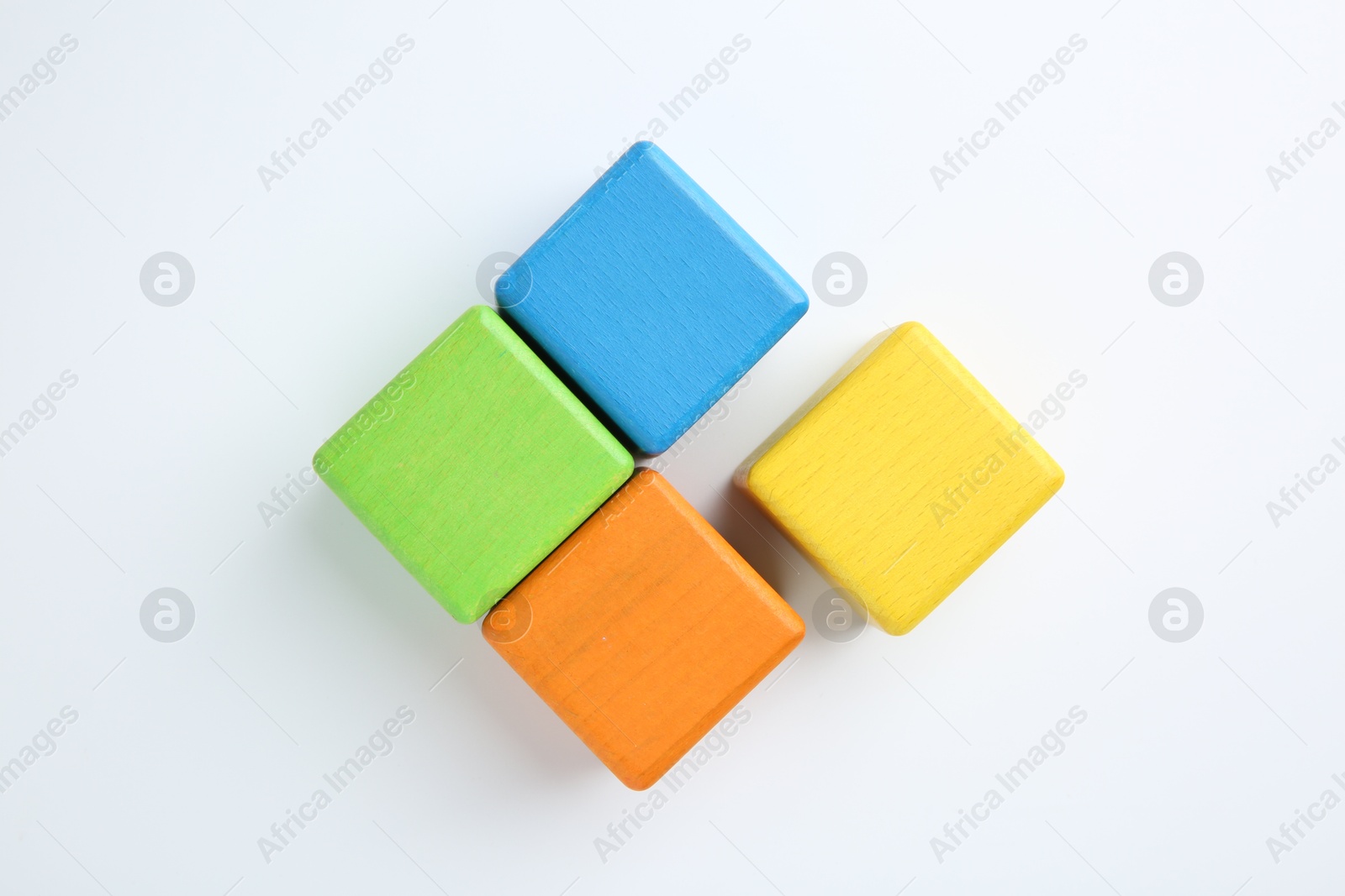 Photo of Many wooden colorful cubes on white background, top view