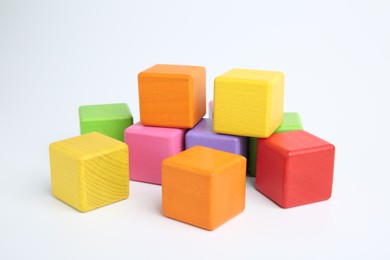 Photo of Many wooden colorful cubes on white background