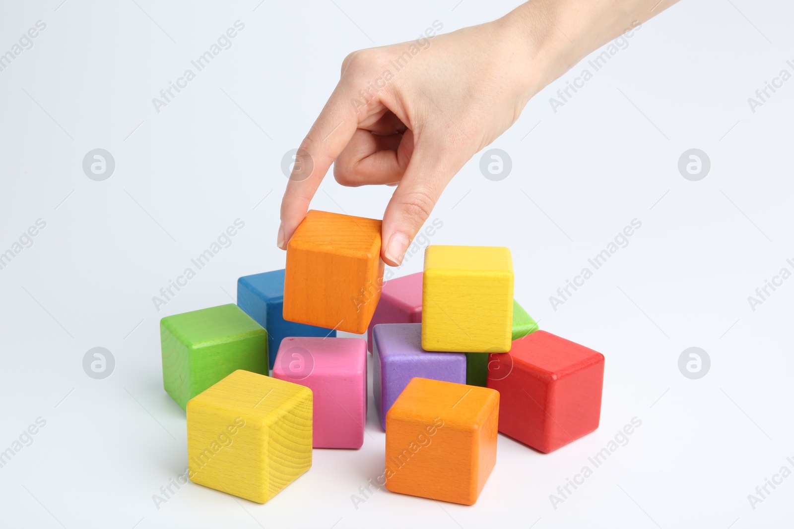 Photo of Woman with colorful cubes on white background, closeup