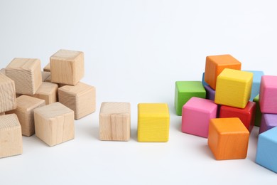 Photo of Many wooden colorful cubes on white background