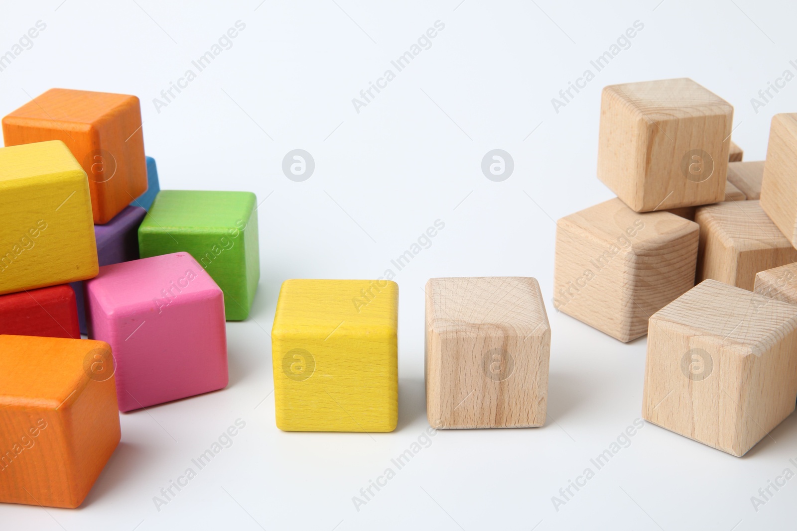 Photo of Many wooden colorful cubes on white background