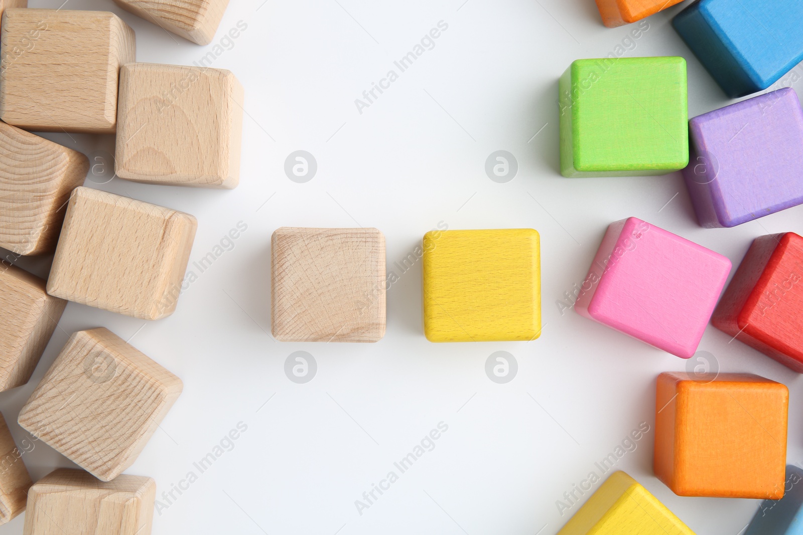 Photo of Many wooden colorful cubes on white background, top view