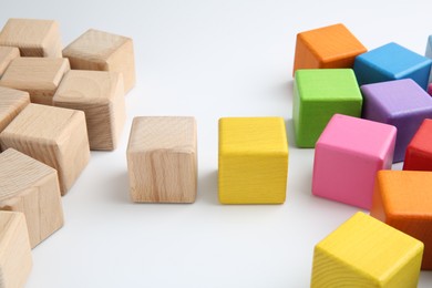 Photo of Many wooden colorful cubes on white background