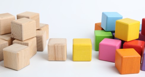 Photo of Many wooden colorful cubes on white background