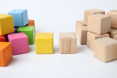 Photo of Many wooden colorful cubes on white background