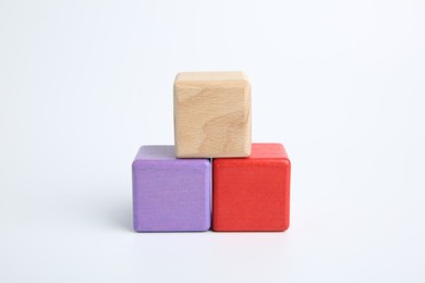 Photo of Pyramid of colorful cubes on white background