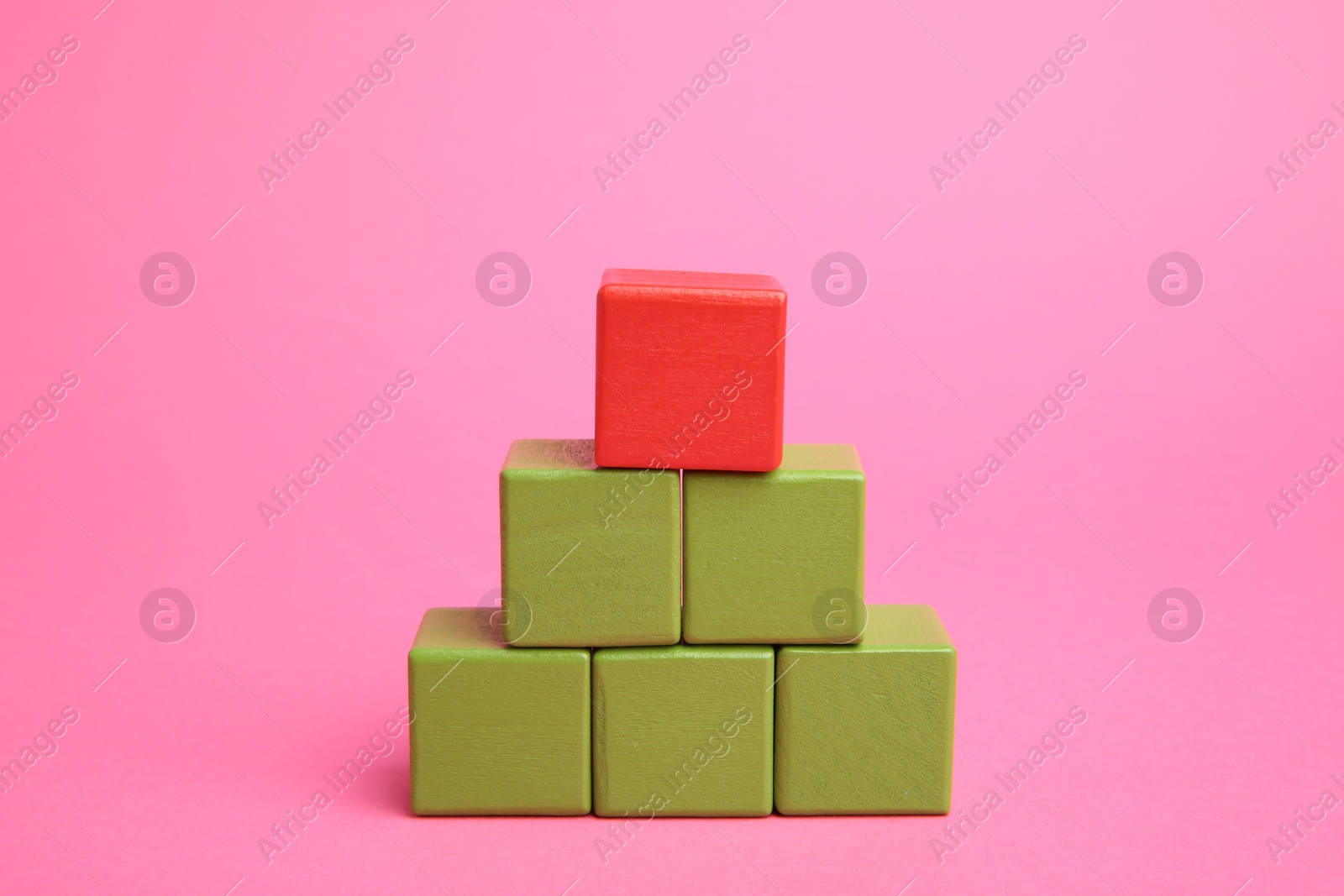 Photo of Pyramid of colorful cubes on pink background