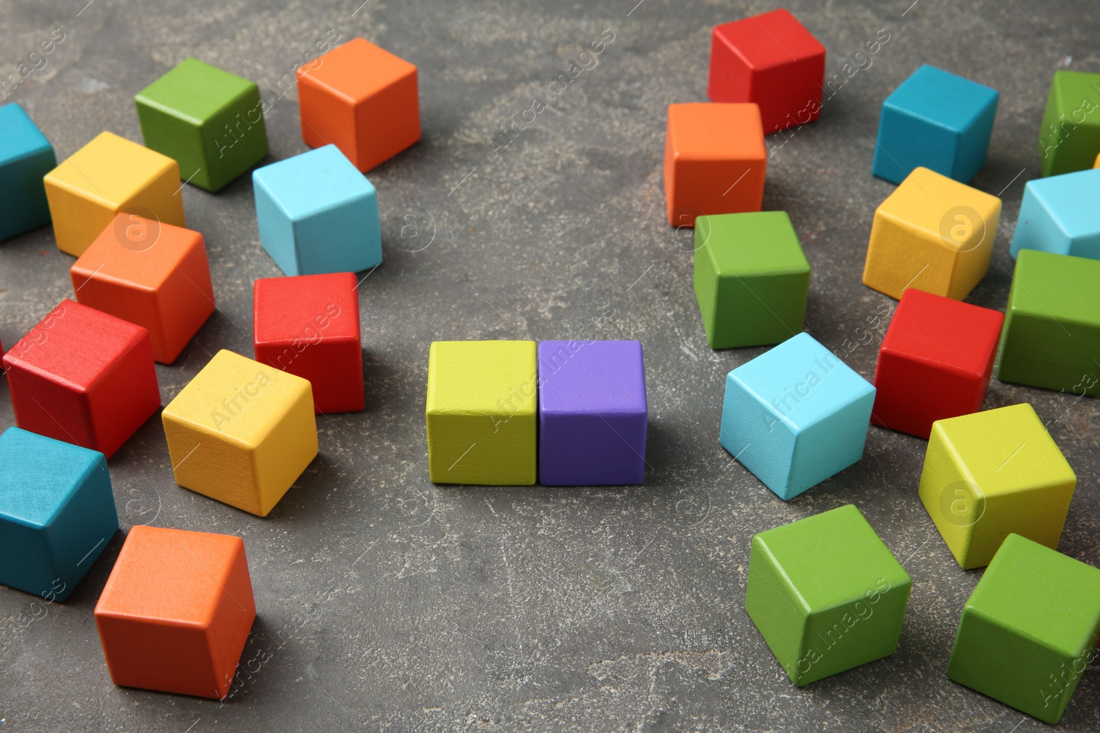 Photo of Many wooden colorful cubes on gray textured background