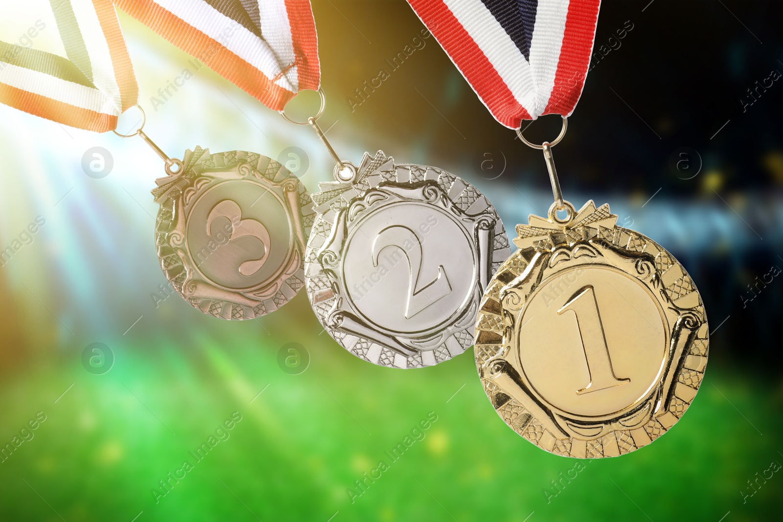 Image of Gold, silver and bronze medals at sports field