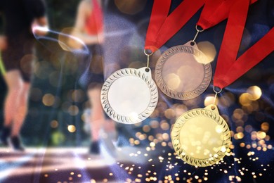 Image of Gold, silver and bronze medals. People running on background