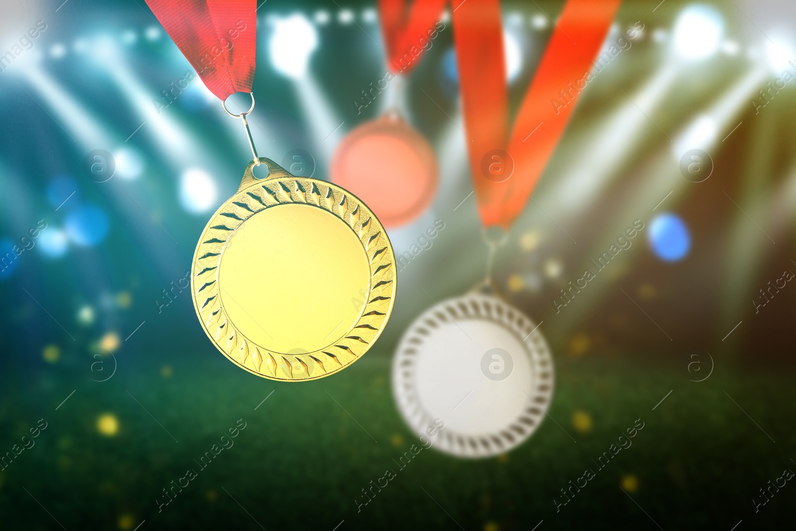 Image of Gold, silver and bronze medals at sports field