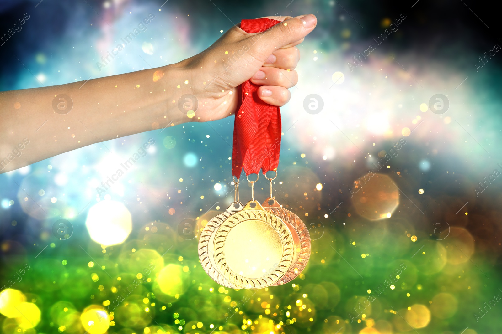 Image of Woman with different medals at sports field, closeup