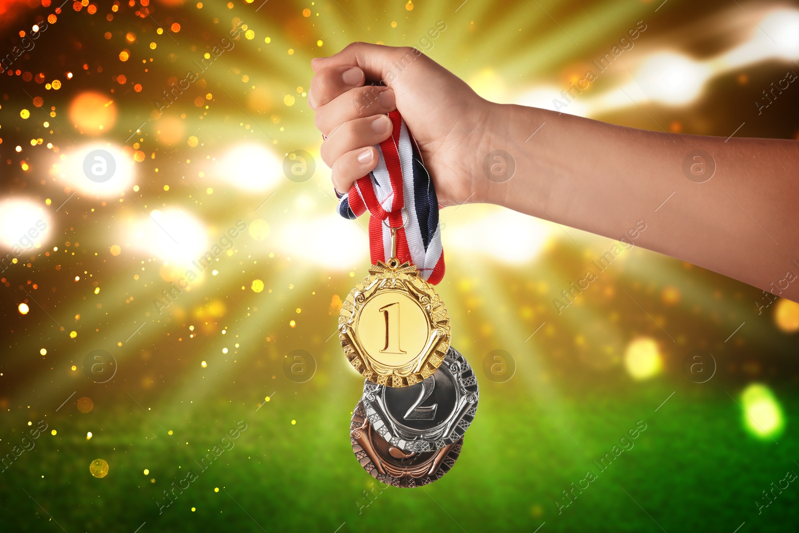 Image of Woman with different medals at sports field, closeup