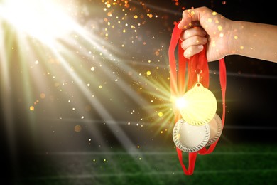 Image of Woman with different medals at sports field, closeup