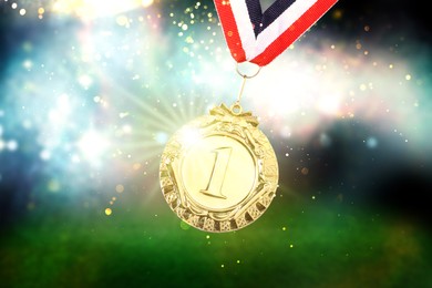 First place gold medal at sports field, closeup