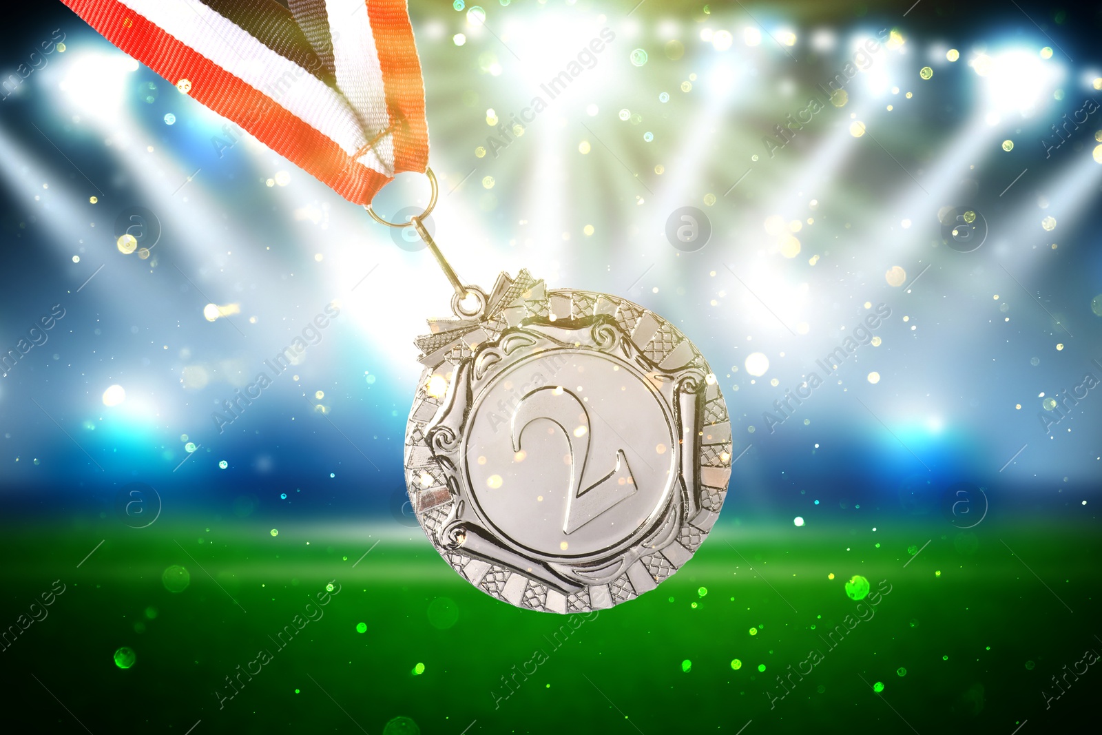 Image of Second place silver medal at sports field, closeup