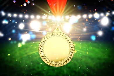 Image of Gold prize medal at sports field, closeup