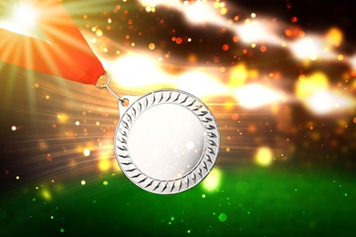 Silver prize medal at sports field, closeup