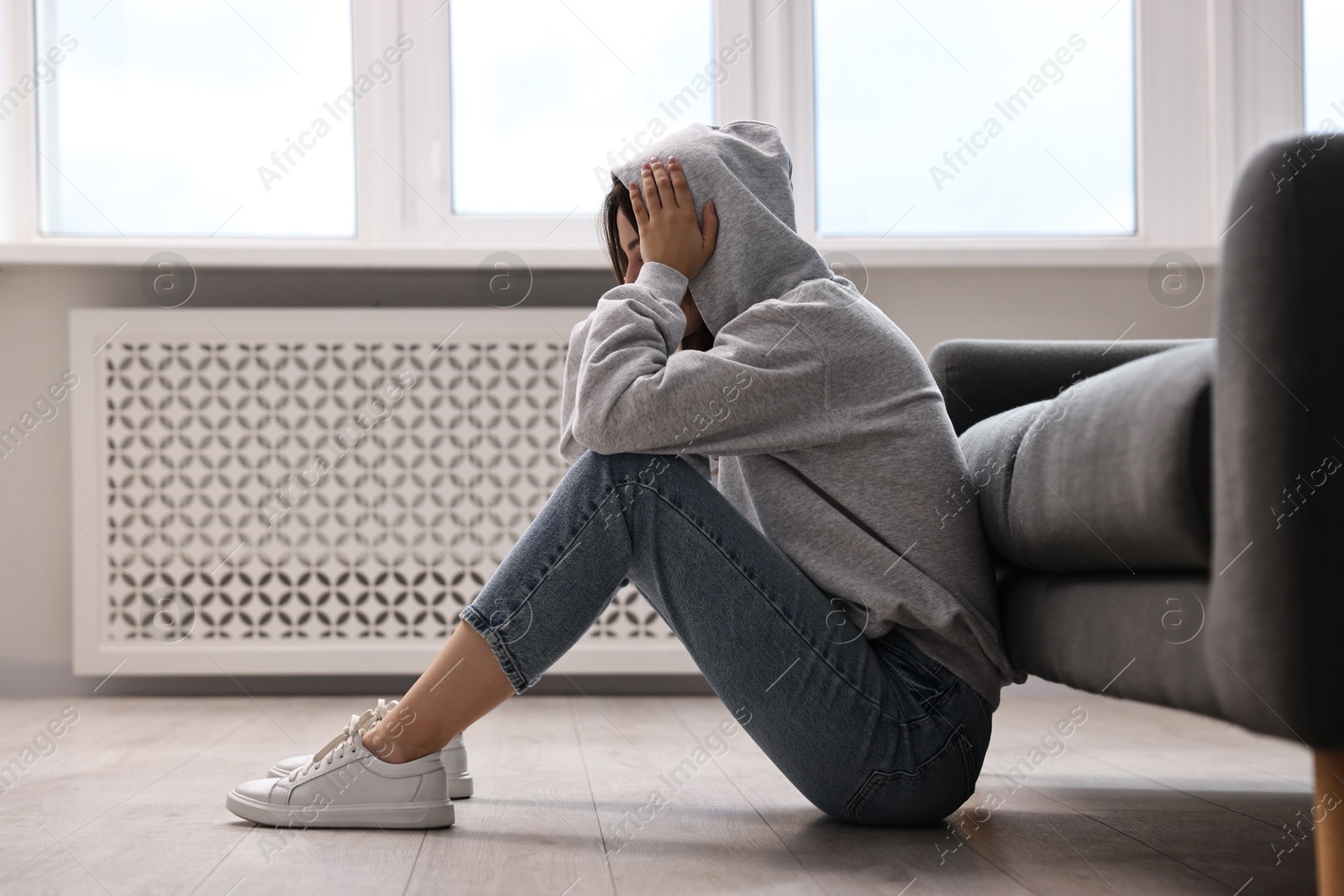 Photo of Loneliness concept. Teenage girl on floor at home