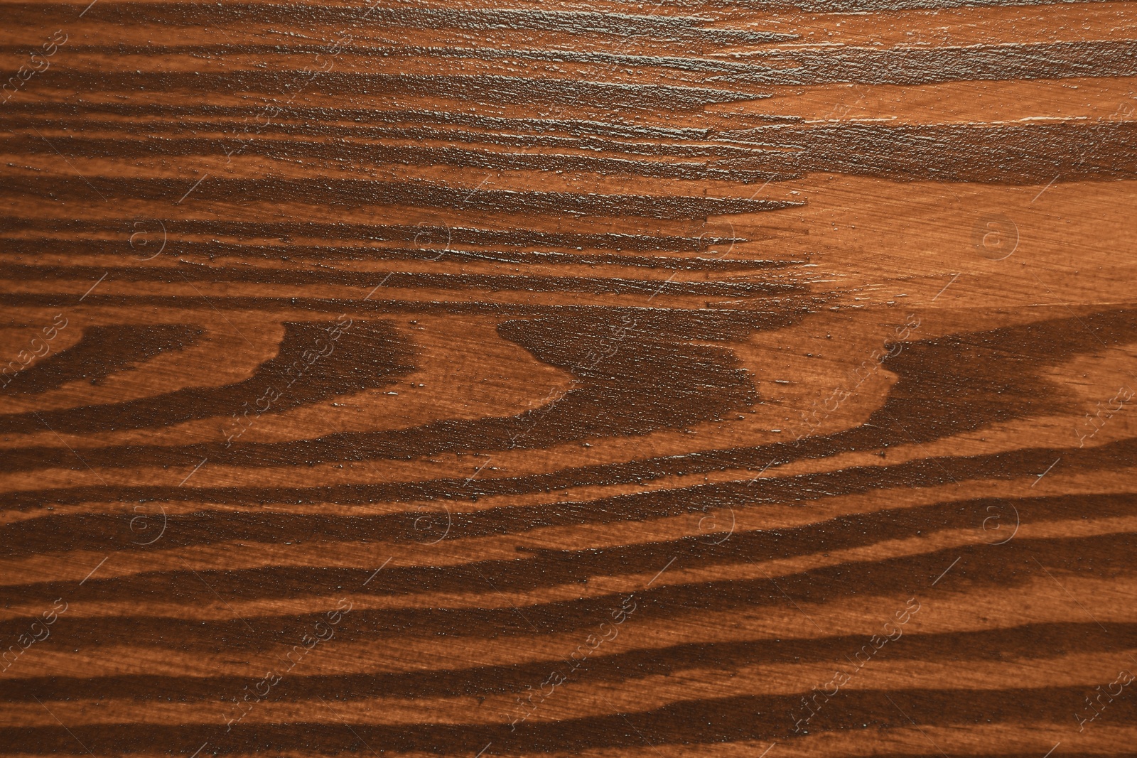 Photo of Texture of wooden surface after applying walnut wood stain as background, top view