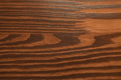 Photo of Texture of wooden surface after applying walnut wood stain as background, top view