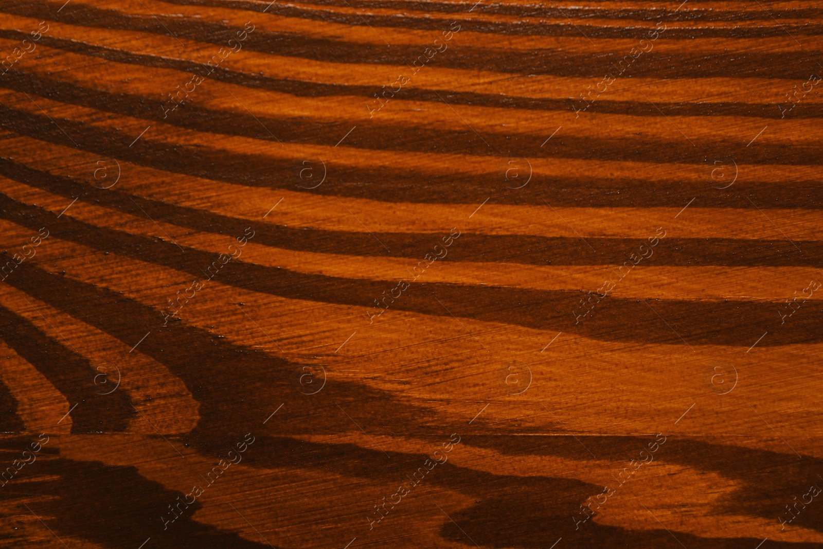 Photo of Texture of wooden surface after applying walnut wood stain as background, top view