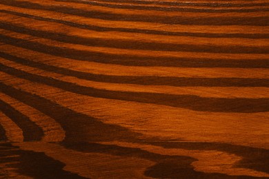 Texture of wooden surface after applying walnut wood stain as background, top view