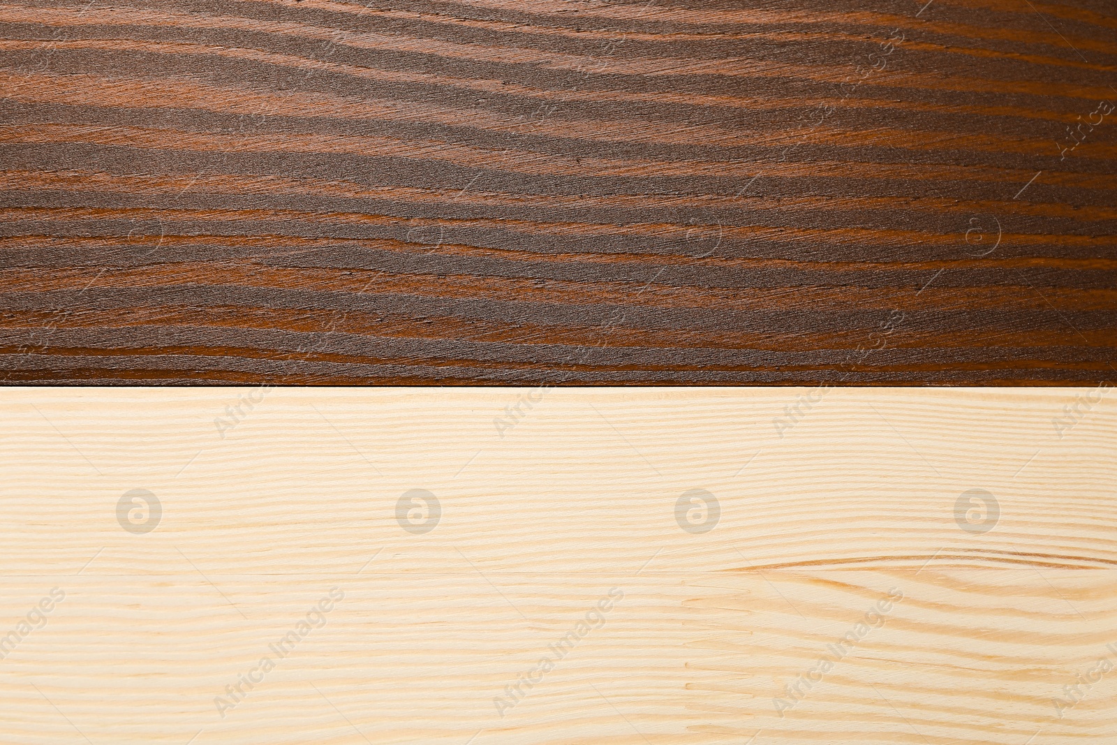 Photo of Applying walnut wood stain. Texture of wooden surface as background, top view